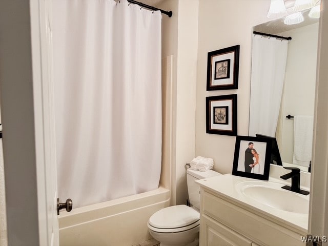 full bathroom featuring shower / bath combo, vanity, and toilet