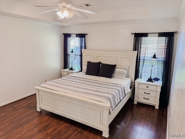 bedroom featuring dark hardwood / wood-style flooring, ceiling fan, and ornamental molding