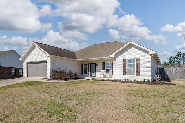 ranch-style house featuring a garage, a front yard, fence, and brick siding