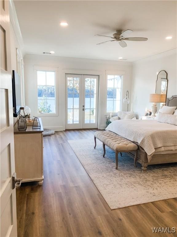 bedroom with ceiling fan, access to outside, dark hardwood / wood-style floors, and multiple windows