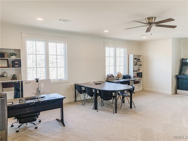 office space featuring light colored carpet and ceiling fan