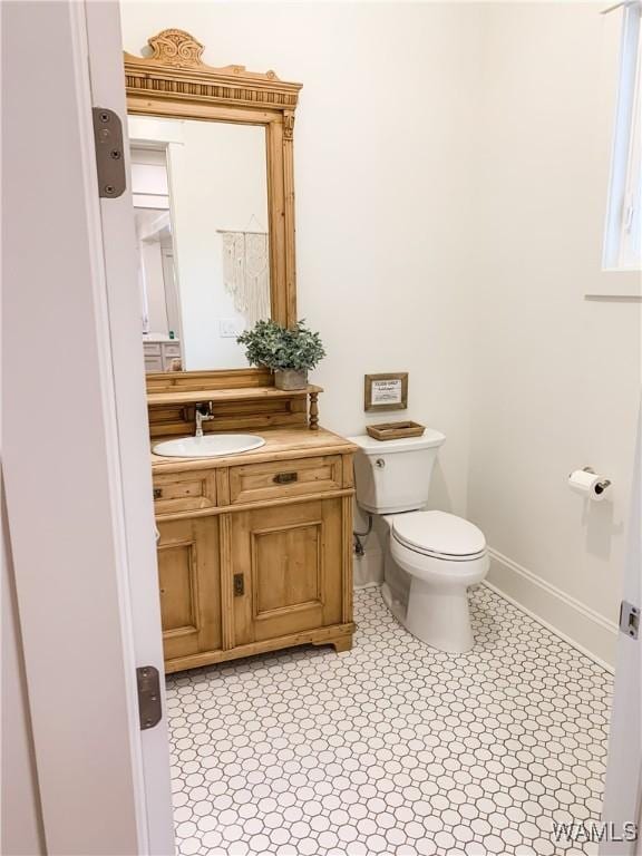 bathroom featuring toilet and vanity