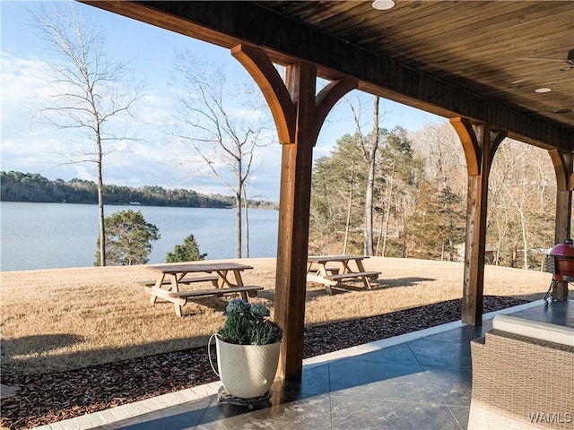 view of patio / terrace featuring a water view and ceiling fan