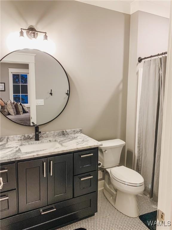 bathroom with vanity, toilet, a shower with shower curtain, and tile patterned flooring