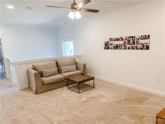 living room with ceiling fan, carpet, and ornamental molding