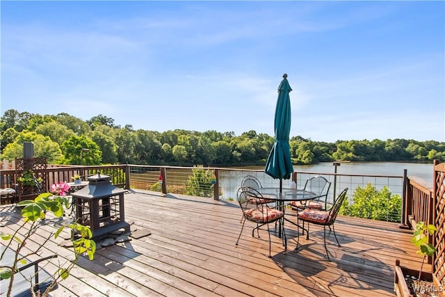 4468 21st St, Northport, AL 35476 - wooden deck featuring outdoor dining area, a water view, and a forest view