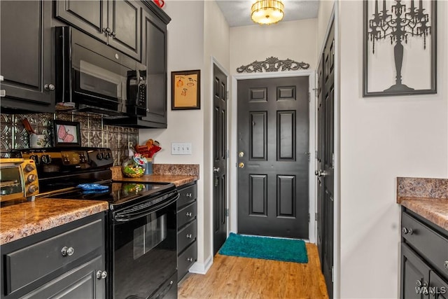 4468 21st St, Northport, AL 35476 - kitchen featuring black appliances, light wood-style flooring, and baseboards