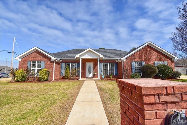 single story home featuring brick siding and a front lawn