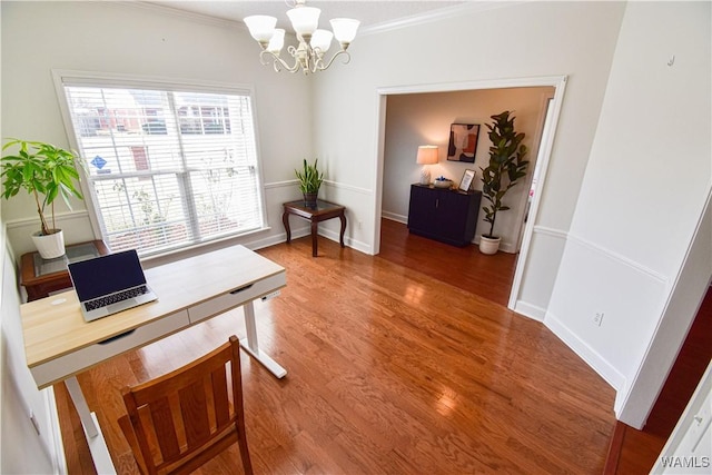 home office with ornamental molding, a notable chandelier, baseboards, and wood finished floors