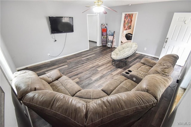 living room with dark wood-type flooring and ceiling fan