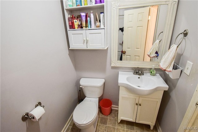 bathroom featuring vanity, tile patterned floors, and toilet