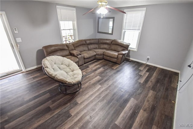 living room featuring ceiling fan and dark hardwood / wood-style floors