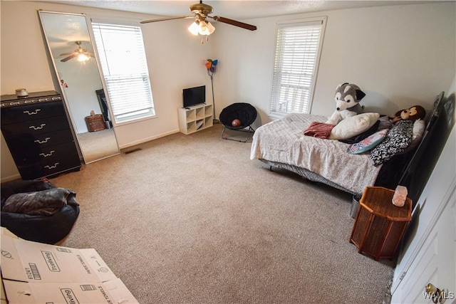 bedroom with multiple windows, carpet flooring, and ceiling fan