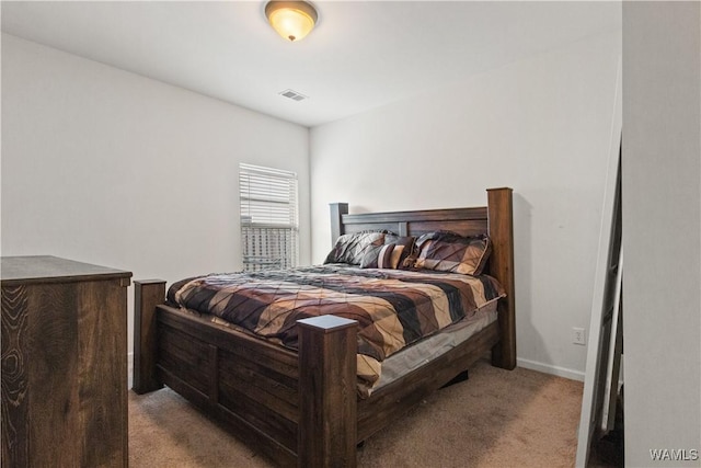 bedroom with light colored carpet