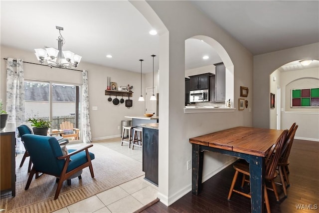 dining room with an inviting chandelier and light hardwood / wood-style floors