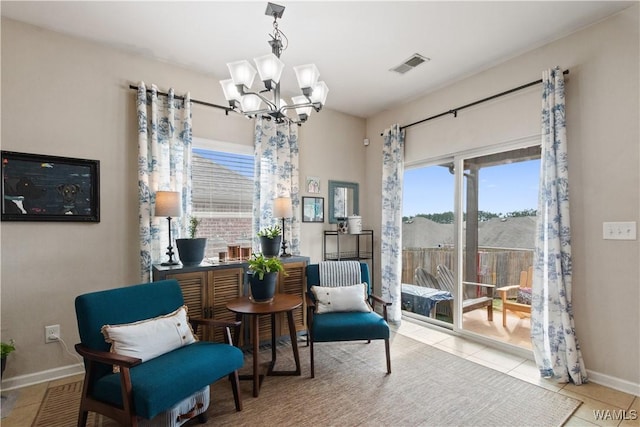 living area featuring light tile patterned floors and a notable chandelier