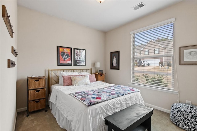 bedroom with multiple windows and light carpet