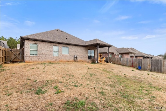 rear view of house with a lawn