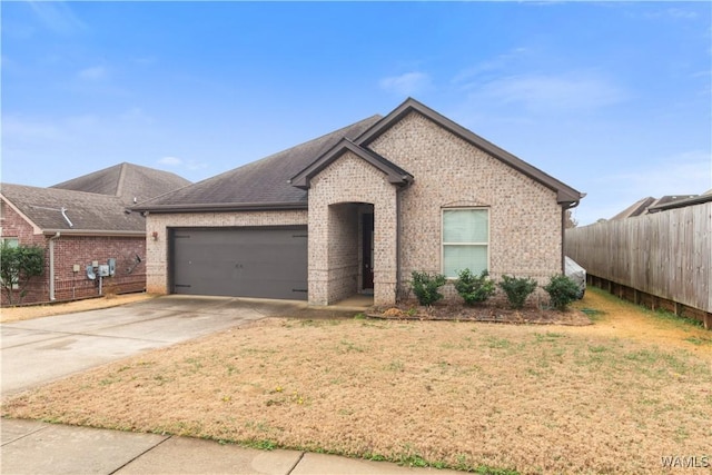 view of front of property with a garage and a front yard