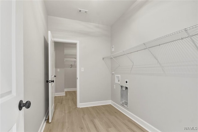 washroom with laundry area, light wood finished floors, visible vents, hookup for an electric dryer, and washer hookup