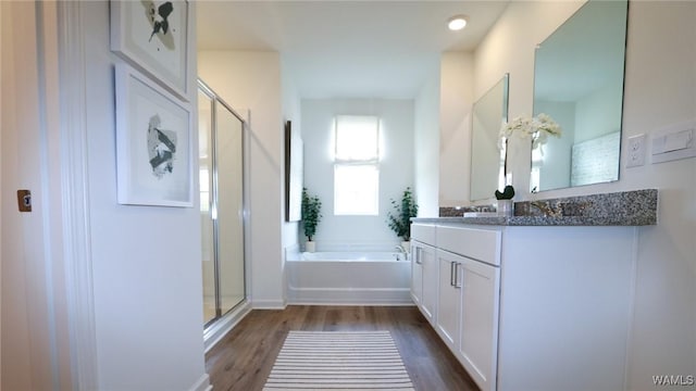 9349 Havenridge Loop, Tuscaloosa, AL 35405 - full bathroom with vanity, a shower stall, a bath, and wood finished floors