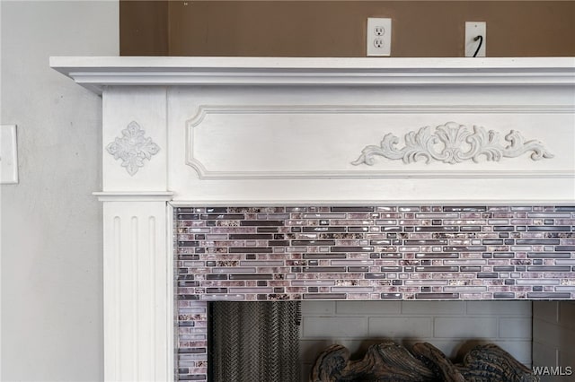 interior details with a brick fireplace