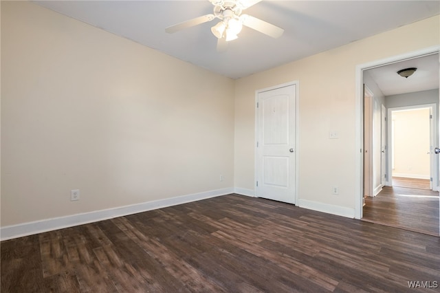 empty room featuring ceiling fan and dark hardwood / wood-style floors