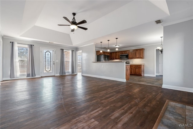 unfurnished living room featuring ceiling fan with notable chandelier, dark hardwood / wood-style flooring, a tray ceiling, and ornamental molding