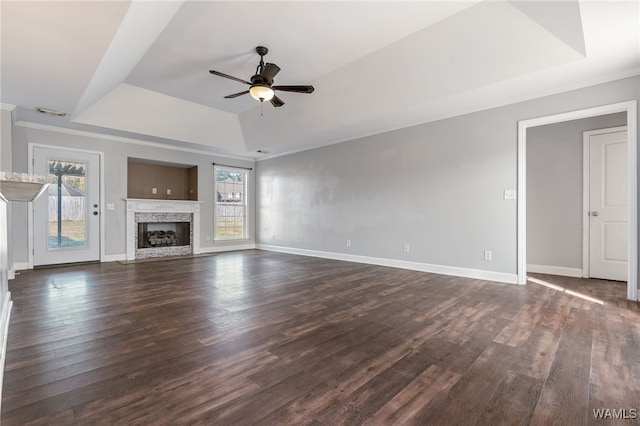 unfurnished living room with a wealth of natural light, ceiling fan, and dark hardwood / wood-style floors