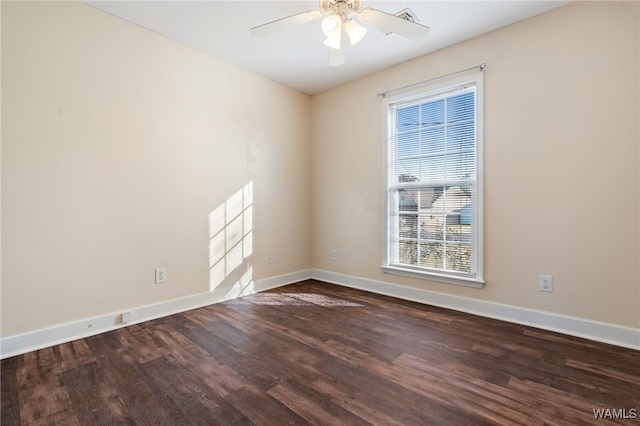 spare room featuring ceiling fan and dark wood-type flooring