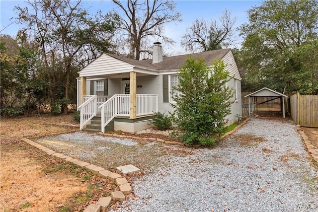 bungalow-style home with a carport and covered porch