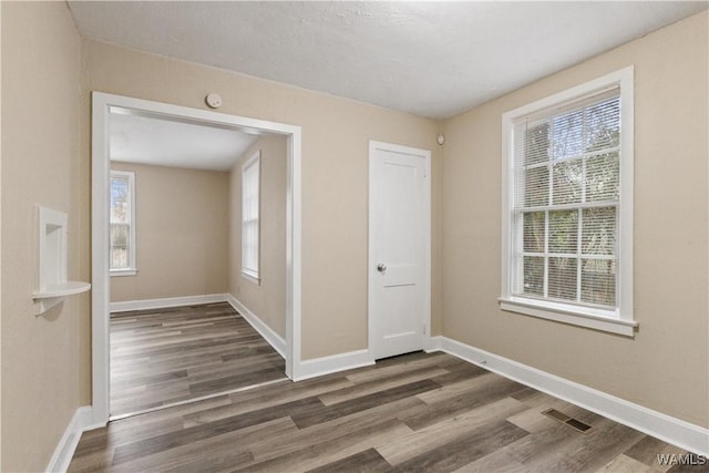 spare room with dark hardwood / wood-style flooring