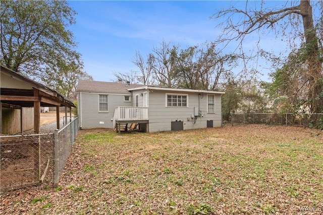 rear view of property featuring a yard