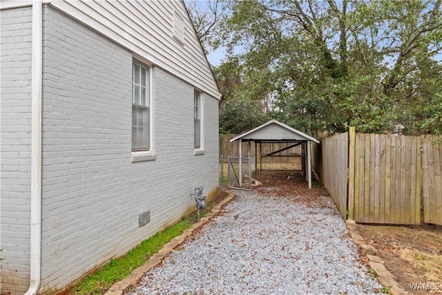 view of side of home with a carport