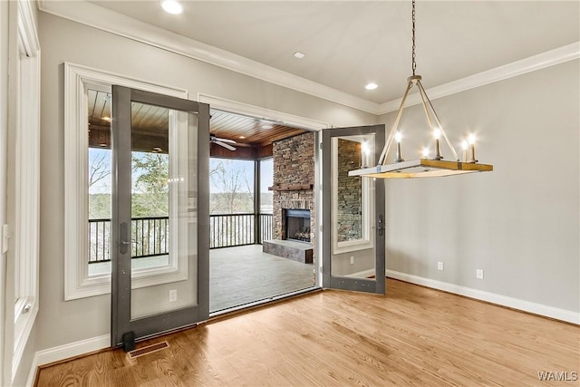 10416 Harbourtowne Dr, Northport, AL 35475 - unfurnished dining area with wood finished floors, crown molding, a fireplace, and recessed lighting