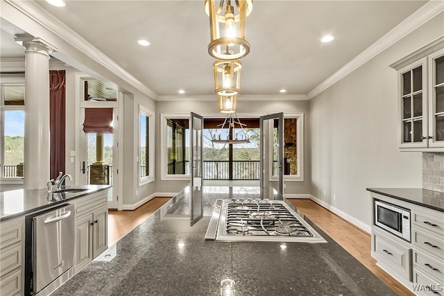 10416 Harbourtowne Dr, Northport, AL 35475 - kitchen with stainless steel appliances, glass insert cabinets, recessed lighting, dark stone countertops, and light wood-style flooring