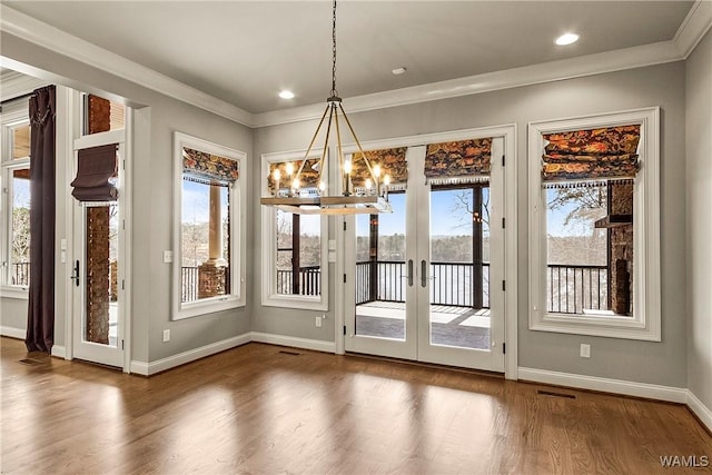 10416 Harbourtowne Dr, Northport, AL 35475 - unfurnished dining area with a chandelier, ornamental molding, wood finished floors, french doors, and a water view