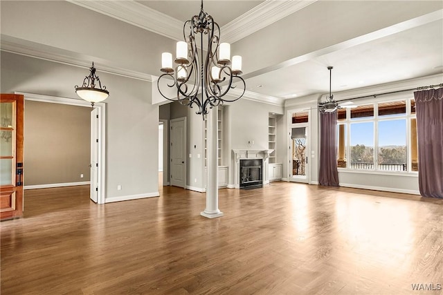 10416 Harbourtowne Dr, Northport, AL 35475 - unfurnished living room with a chandelier, crown molding, wood finished floors, built in features, and a fireplace
