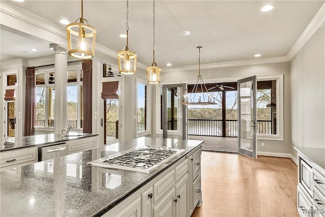 10416 Harbourtowne Dr, Northport, AL 35475 - kitchen featuring stainless steel appliances, healthy amount of natural light, ornamental molding, white cabinets, and decorative light fixtures