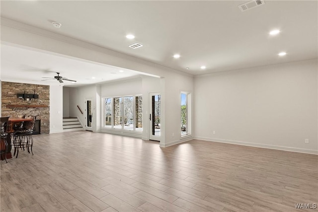 10416 Harbourtowne Dr, Northport, AL 35475 - unfurnished living room featuring light wood-type flooring, crown molding, recessed lighting, stairway, and ceiling fan