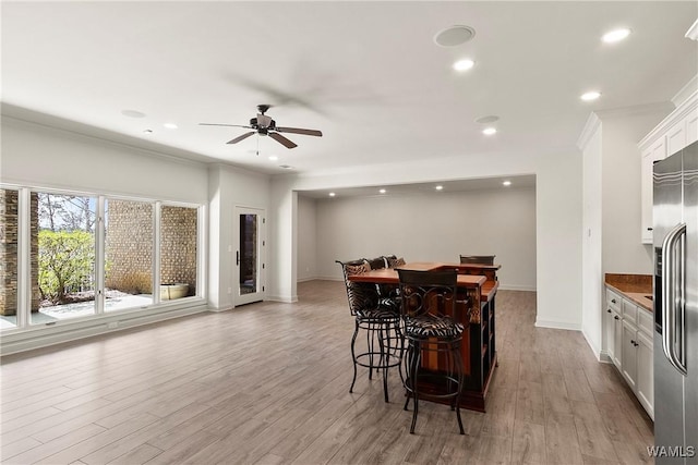 10416 Harbourtowne Dr, Northport, AL 35475 - dining room featuring crown molding, ceiling fan, light wood finished floors, recessed lighting, and a bar
