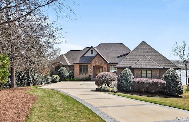 10416 Harbourtowne Dr, Northport, AL 35475 - french country home with brick siding, concrete driveway, and a front yard