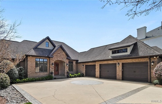 10416 Harbourtowne Dr, Northport, AL 35475 - view of front facade with brick siding, a garage, driveway, and a shingled roof