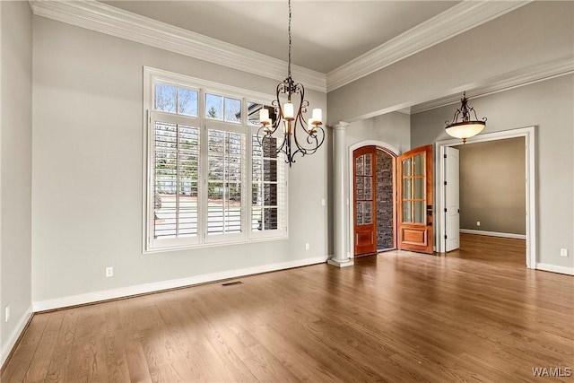 10416 Harbourtowne Dr, Northport, AL 35475 - unfurnished dining area with wood finished floors, crown molding, and a chandelier