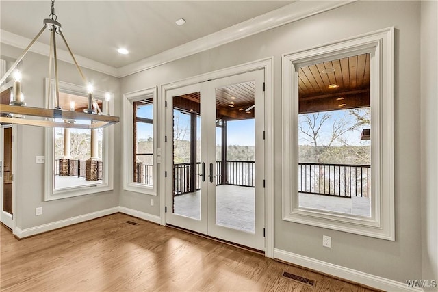 10416 Harbourtowne Dr, Northport, AL 35475 - entryway with plenty of natural light, ornamental molding, wood finished floors, and french doors