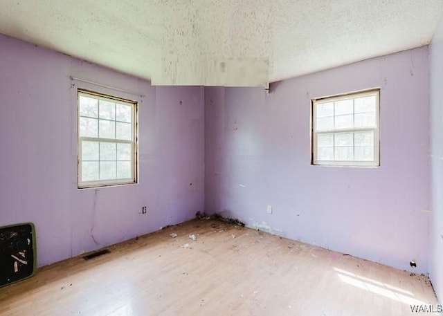 120 John Watkins Ln, Dora, AL 35062 - empty room featuring a textured ceiling, visible vents, and light wood-type flooring