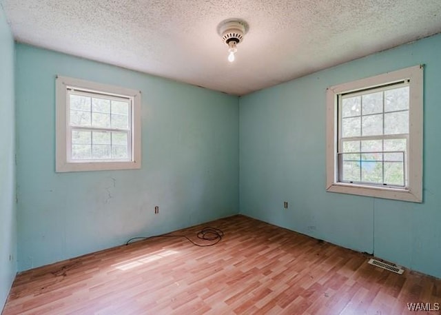 120 John Watkins Ln, Dora, AL 35062 - empty room with a textured ceiling, visible vents, and wood finished floors