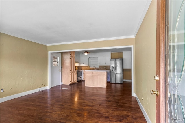 unfurnished living room featuring dark hardwood / wood-style floors, ornamental molding, and sink