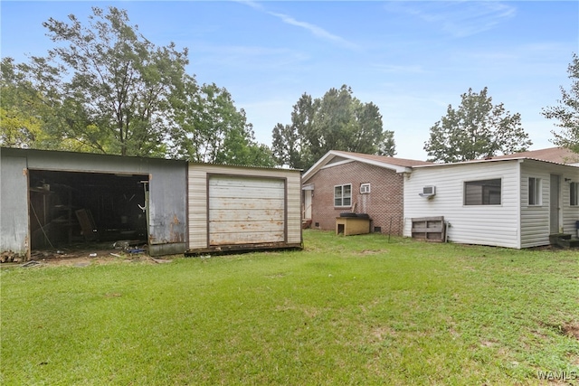 back of property with an outbuilding and a yard