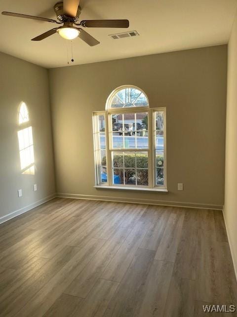 empty room with wood-type flooring and ceiling fan